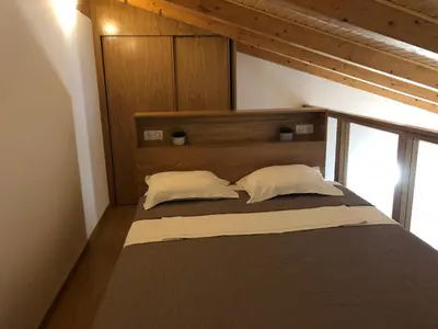 a bed with two pillows on it in a room at Résidence Porto Marine in Porto Ota