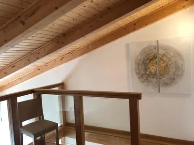 a chair in a room with a wooden ceiling at Résidence Porto Marine in Porto Ota