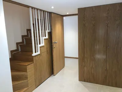 a hallway with a wooden door and stairs at Résidence Porto Marine in Porto Ota
