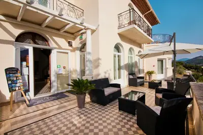 a patio with couches and chairs on a building at Si Mea in Corte