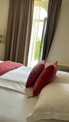 two pillows sitting on top of a bed with a window at Si Mea in Corte