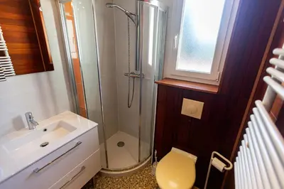 a bathroom with a shower and a toilet and a sink at Résidence Padro in Calvi