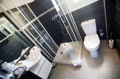 a bathroom with a toilet and a sink and a shower at Résidence Padro in Calvi