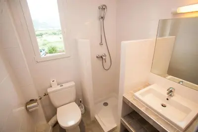 a bathroom with a toilet and a sink at Résidence Padro in Calvi
