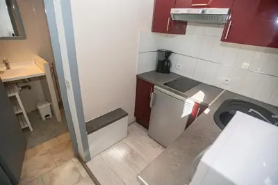 a small kitchen with a sink and a dishwasher at Résidence Padro in Calvi