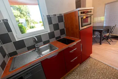 a small kitchen with a sink and a window at Résidence Padro in Calvi
