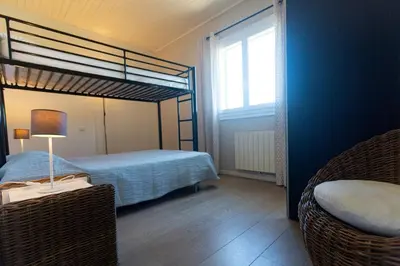 a bedroom with a bunk bed and a window at Résidence Padro in Calvi
