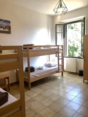 a room with two bunk beds and a window at U Castellu in Vero