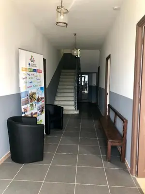 a hallway with a staircase with a bench and a chair at U Castellu in Vero