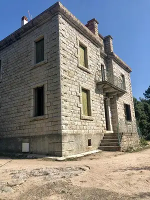 an old brick building with a staircase on it at U Castellu in Vero