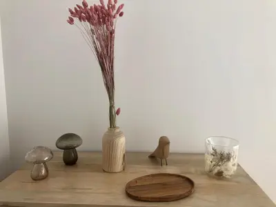 a wooden table with a vase with flowers in it at VILLA GOLFE AJACCIO près des plages in Ajaccio