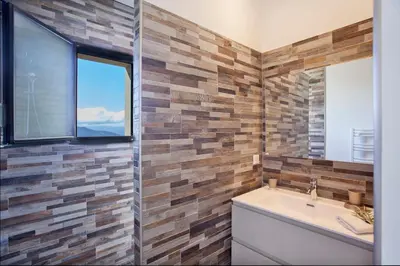 a bathroom with a sink and a window at Villa No Stress Aria di Petra in Olmeto
