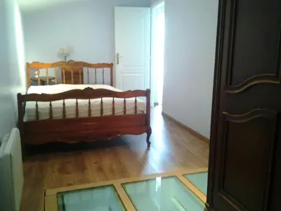 a bedroom with a bed and a glass floor at Maison de village in Moltifao