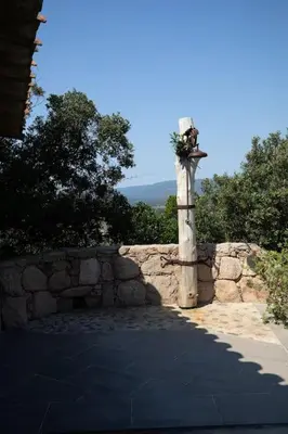 a stone wall next to a stone fence at Casa Laricciu in Figari