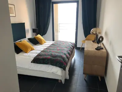 a bedroom with a large bed and a window at T3 vue mer in Propriano