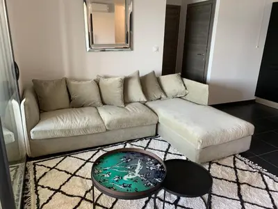 a living room with a couch and a table at T3 vue mer in Propriano