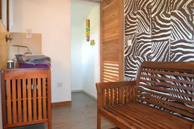 a room with a wooden bench and a wall at Maison de la Vigne in Venzolasca