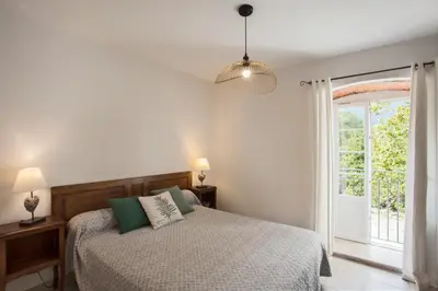 a bedroom with a bed and a window at LA SOURCE 4 chambres in Valle d'Alesani