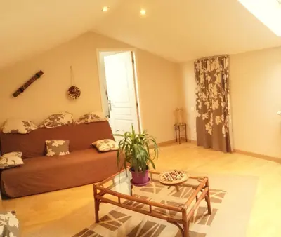 a living room with a couch and a table at Autour du Hamac chambres et table d'hôtes in Moltifao