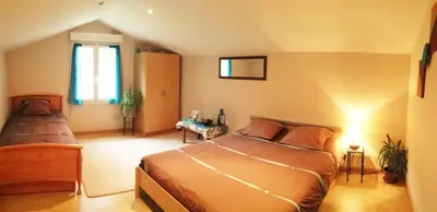 a bedroom with two beds and a window at Autour du Hamac chambres et table d'hôtes in Moltifao