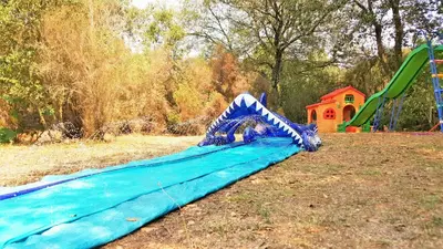a slide on a playground in a park at Autour du Hamac chambres et table d'hôtes in Moltifao