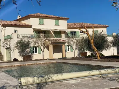 a house with a swimming pool in front of a house at APICULTEUR in Oletta
