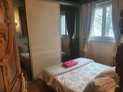 a room with a bed with a pink object on it at maison de charme avec piscine et vue exceptionnelle in Scolca