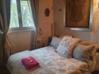 a bed with a pink towel on top of it at maison de charme avec piscine et vue exceptionnelle in Scolca