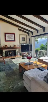 a living room with a couch and a table at maison de charme avec piscine et vue exceptionnelle in Scolca