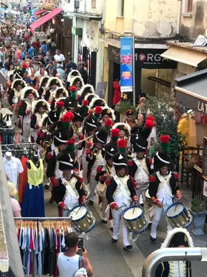 a marching band in a parade down a street at Grand studio rue piétonne Ajaccio in Ajaccio