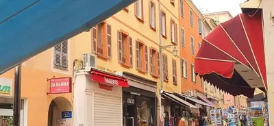 a group of buildings on a city street with shops at Grand studio rue piétonne Ajaccio in Ajaccio