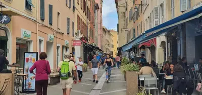 a group of people walking down a city street at STUDIO rue pietonne Ajaccio in Ajaccio