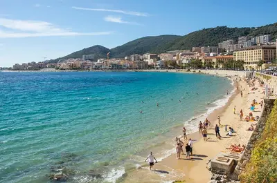a group of people on a beach near the water at STUDIO rue pietonne Ajaccio in Ajaccio
