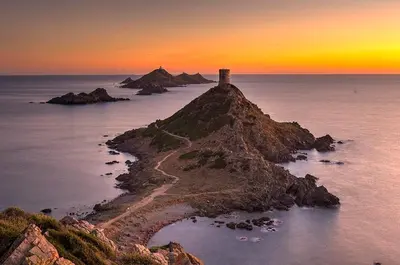 an island in the ocean with a lighthouse on it at STUDIO rue pietonne Ajaccio in Ajaccio