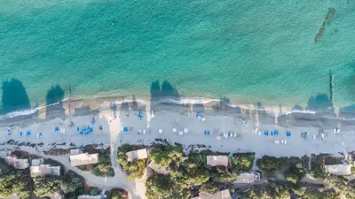 an aerial view of a beach with people and the ocean at Domaine Naturiste de Riva Bella in Linguizzetta