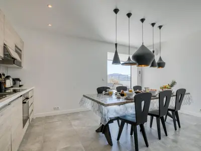 a kitchen and dining room with a table and chairs at Apartment Château-18 by Interhome in Porto-Vecchio