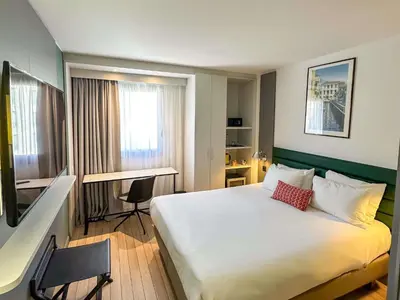 a living room with a purple chair and a table at Mercure Ajaccio in Ajaccio