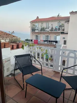 a balcony with chairs and a view of a building at Auberge du cheval blanc in Ajaccio