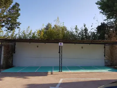a tennis court with a sign on top of it at Golfe Hôtel & Spa Porto-Vecchio in Porto-Vecchio
