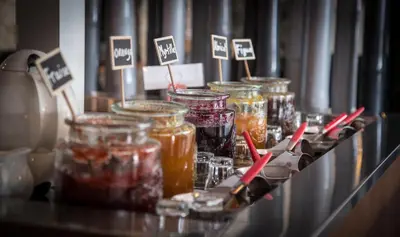 a display of jars of jam on a shelf at Golfe Hôtel & Spa Porto-Vecchio in Porto-Vecchio