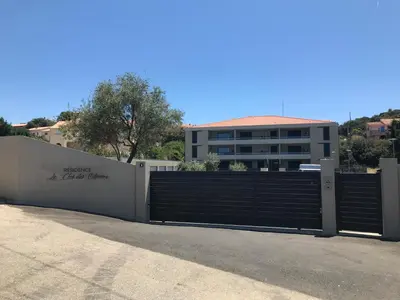 a gate in front of a building with a fence at clos des oliviers in Cargèse