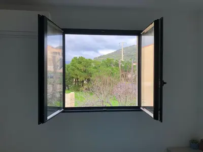 a window in a room with a view at clos des oliviers in Cargèse