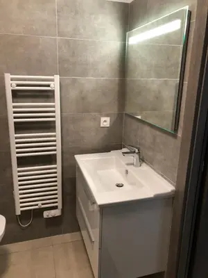 a bathroom with a white sink and a mirror at clos des oliviers in Cargèse