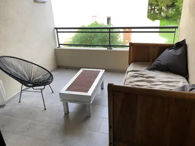 a living room with a couch and a chair at clos des oliviers in Cargèse