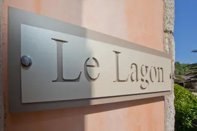 a sign on the side of a building at Villa Le Lagon - Vision Luxe in Bonifacio