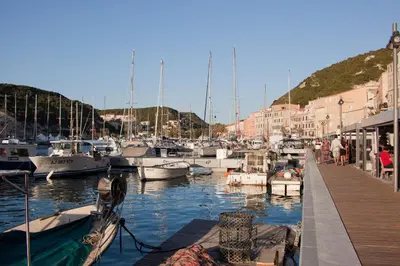 a group of boats docked in a marina with buildings at Villa Le Lagon - Vision Luxe in Bonifacio