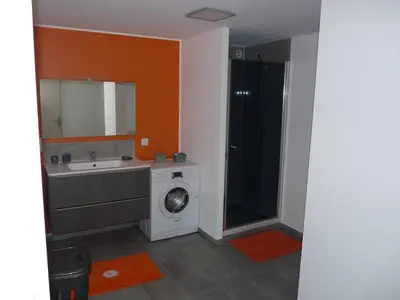 a bathroom with a washing machine and a sink at Le rocher in Porticcio