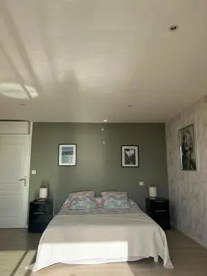 a bedroom with a large bed with two night stands at Le rocher in Porticcio