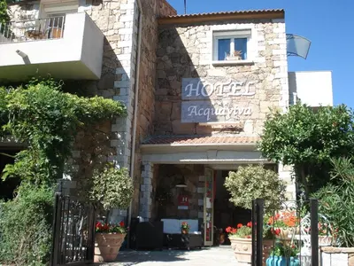 a building with a sign on the front of it at L'Acqua Viva in Calacuccia