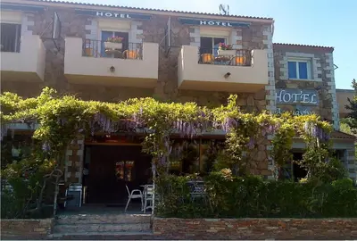 a hotel with plants on the front of a building at L'Acqua Viva in Calacuccia